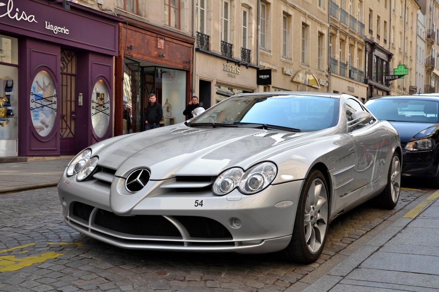 Front grille and headlights of a sleek coupe with aerodynamic body lines.