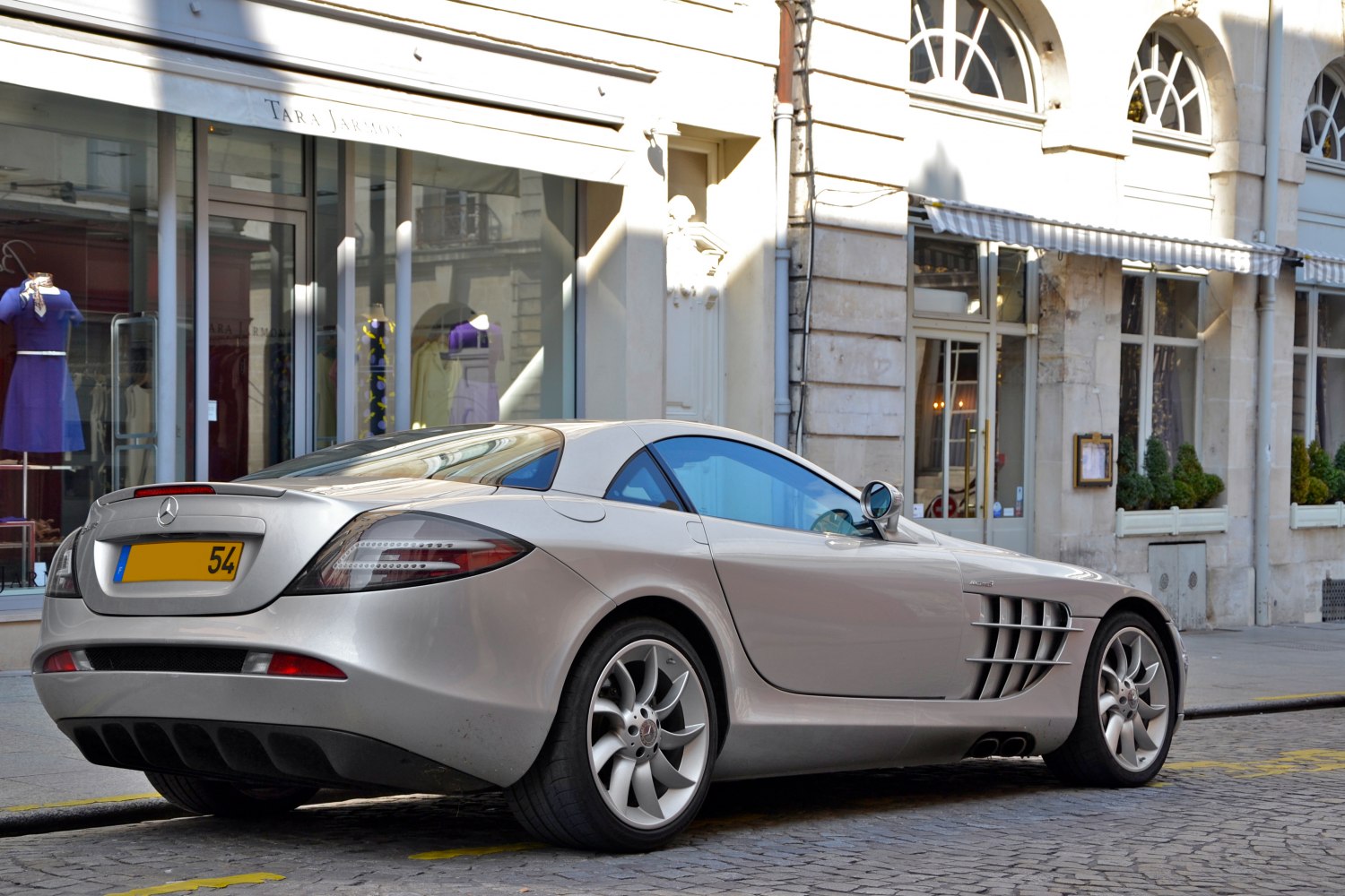 Rear-side view of a coupe with aerodynamic vents and unique wheel design