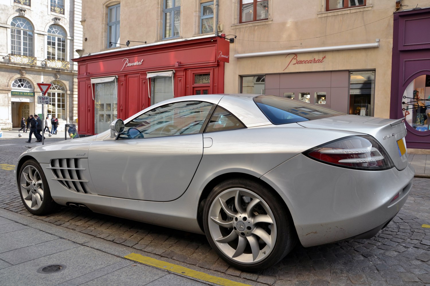 Side and rear view of a silver sports coupe with distinctive alloy wheels