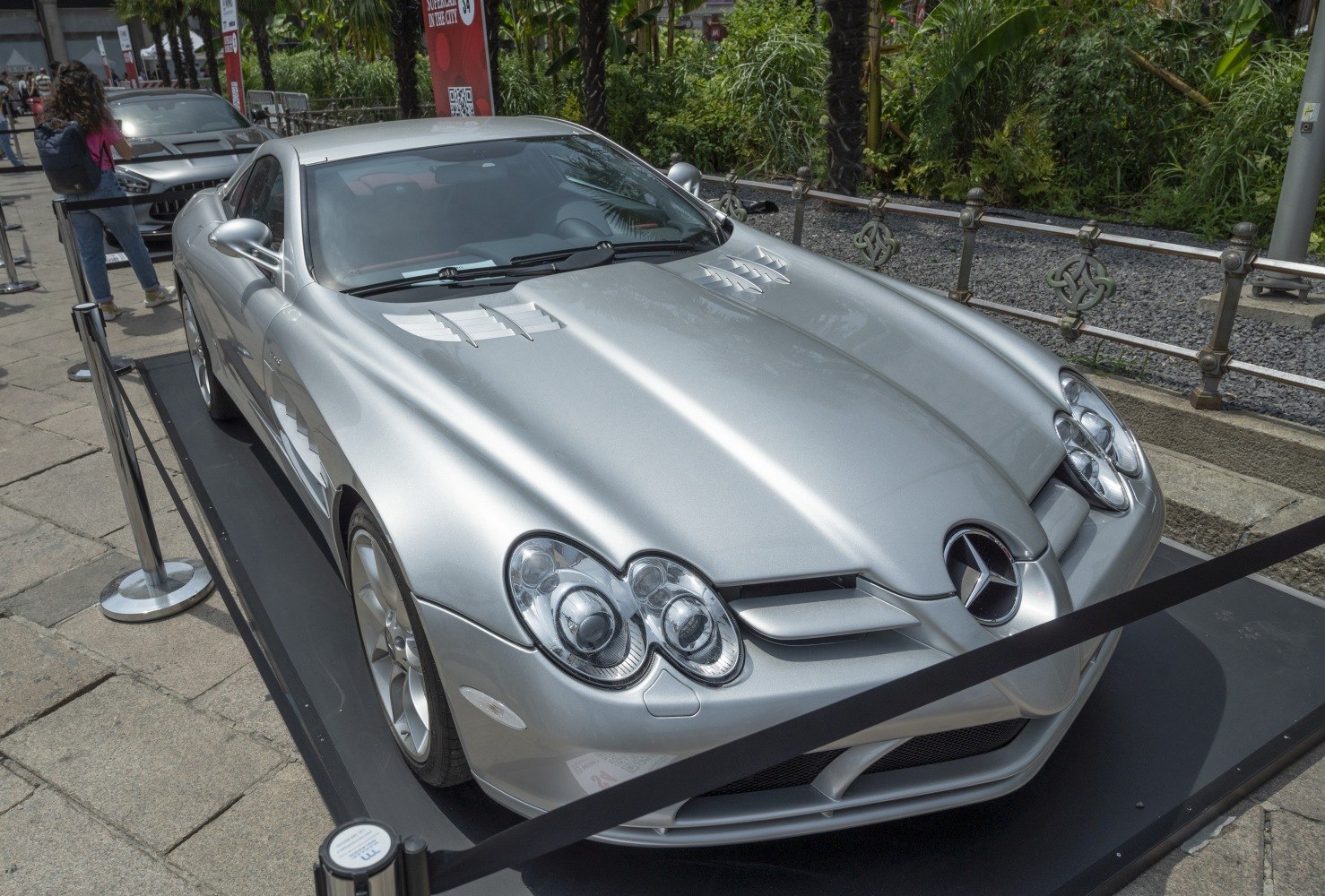 Front view of silver sports coupe with triple headlights and hood vents