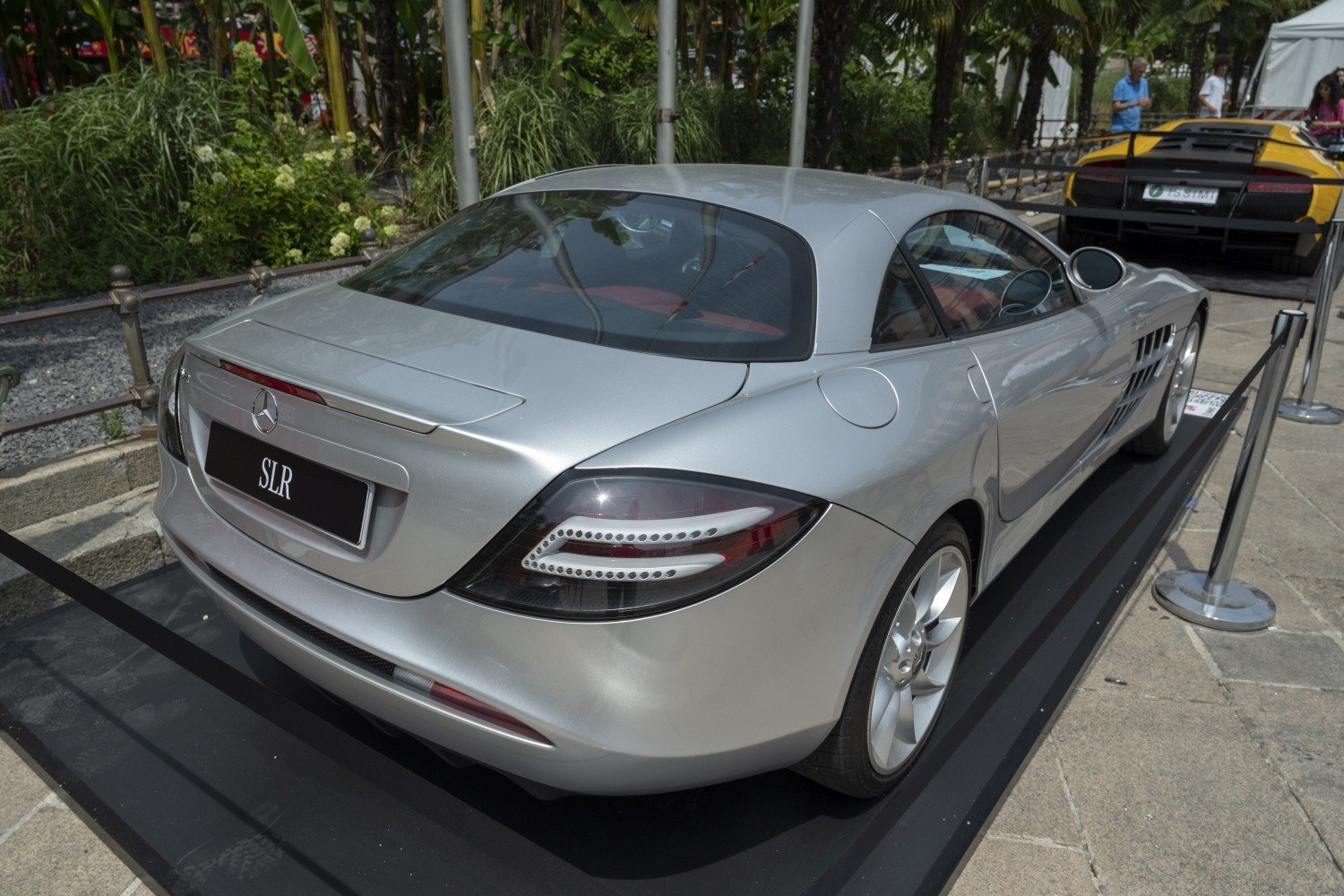 Silver sleek coupe rear with distinctive rear lights.