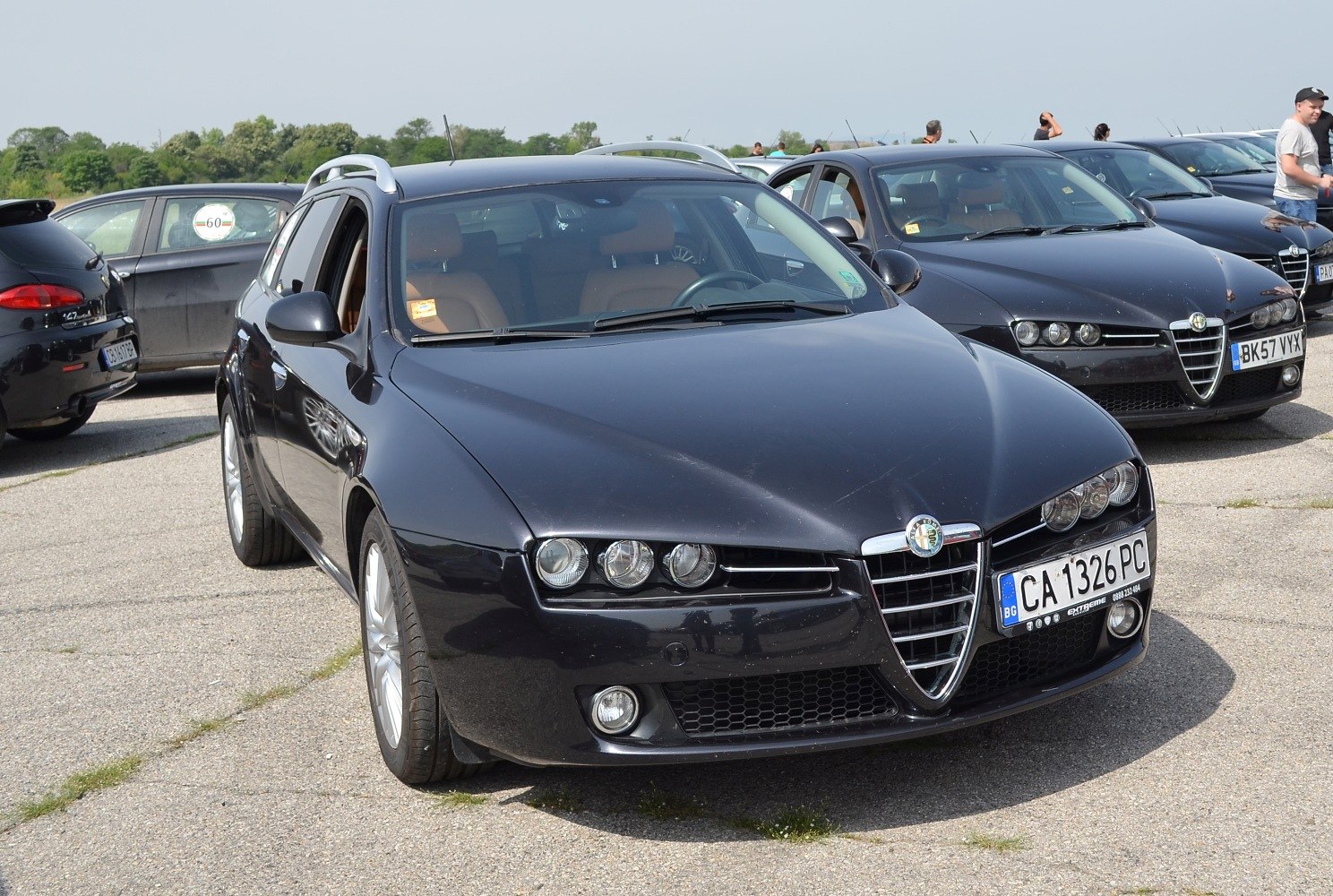 Front close-up showcasing triple headlights and Alfa Romeo triangular grille