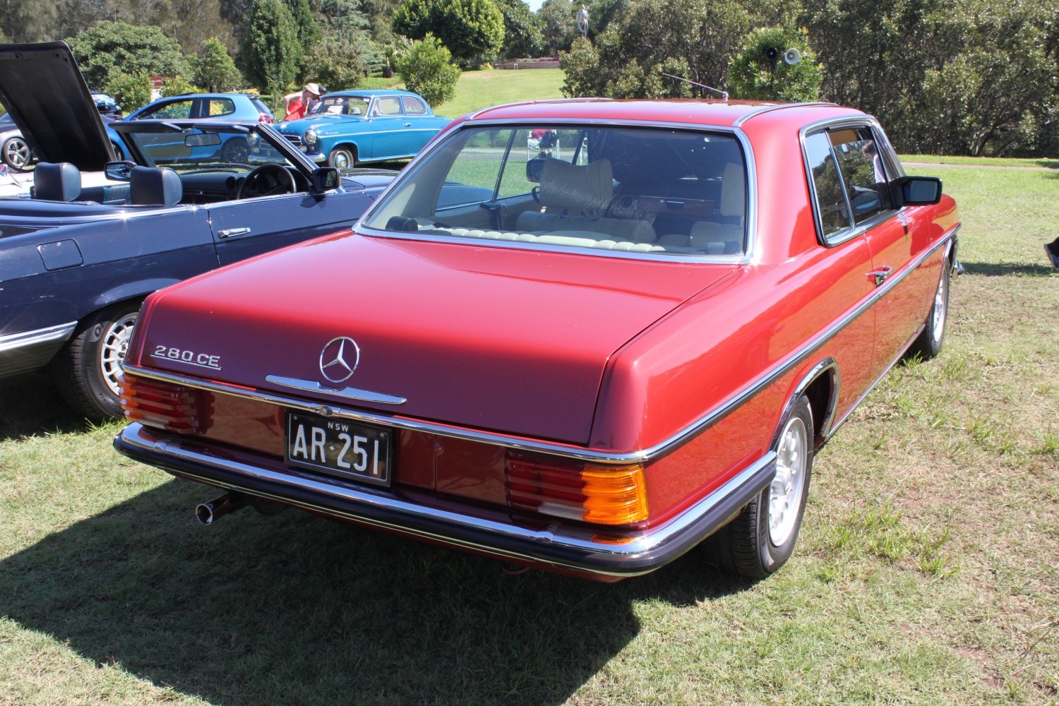 Rear view of classic red coupe with badge and chrome trim