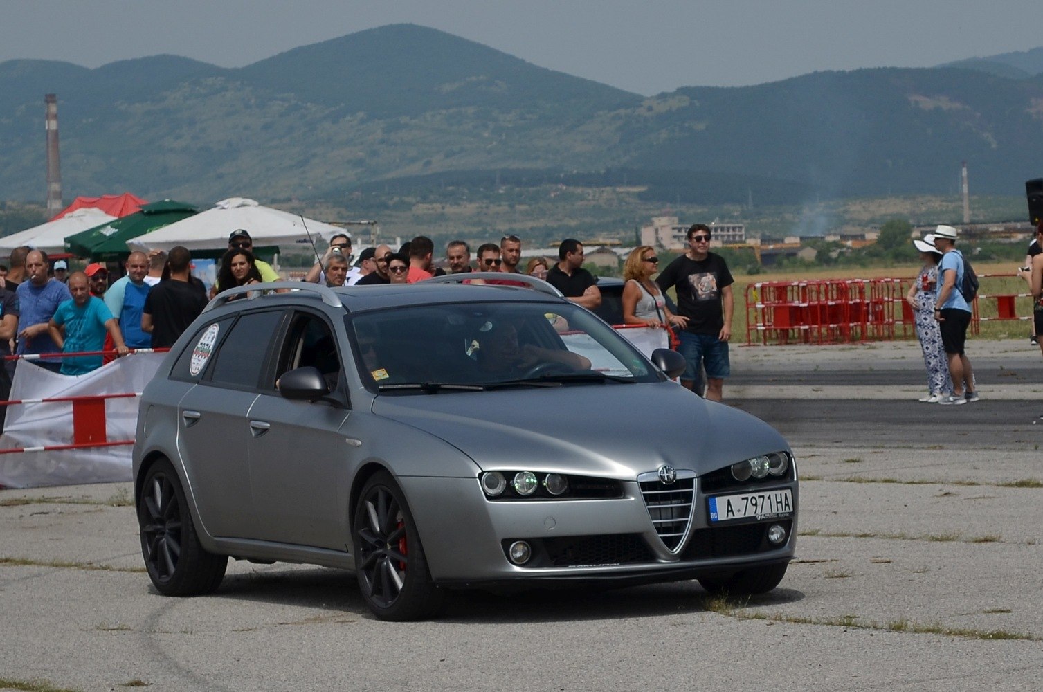 Silver station wagon shown from front angle with sporty wheels and roof rails