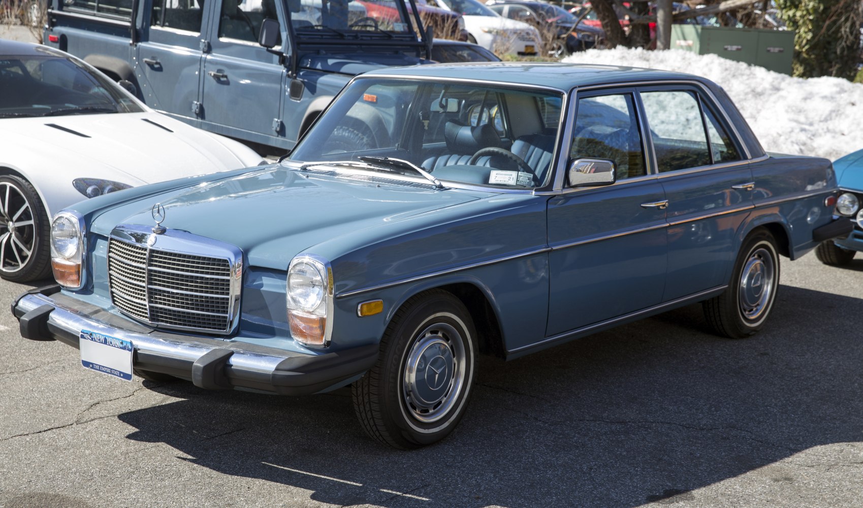 Classic sedan with chrome grille, round headlights, and steel wheels with hubcaps.