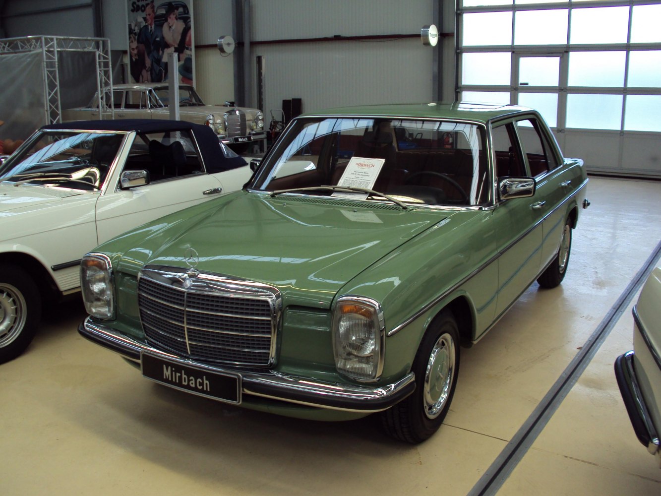 Vintage green 1970s sedan with classic front grille and rectangular headlights