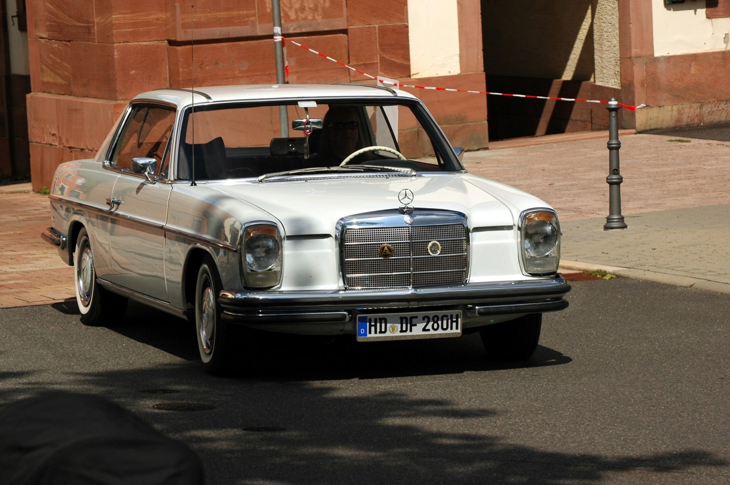 Vintage coupe front view with chrome grill and round headlights