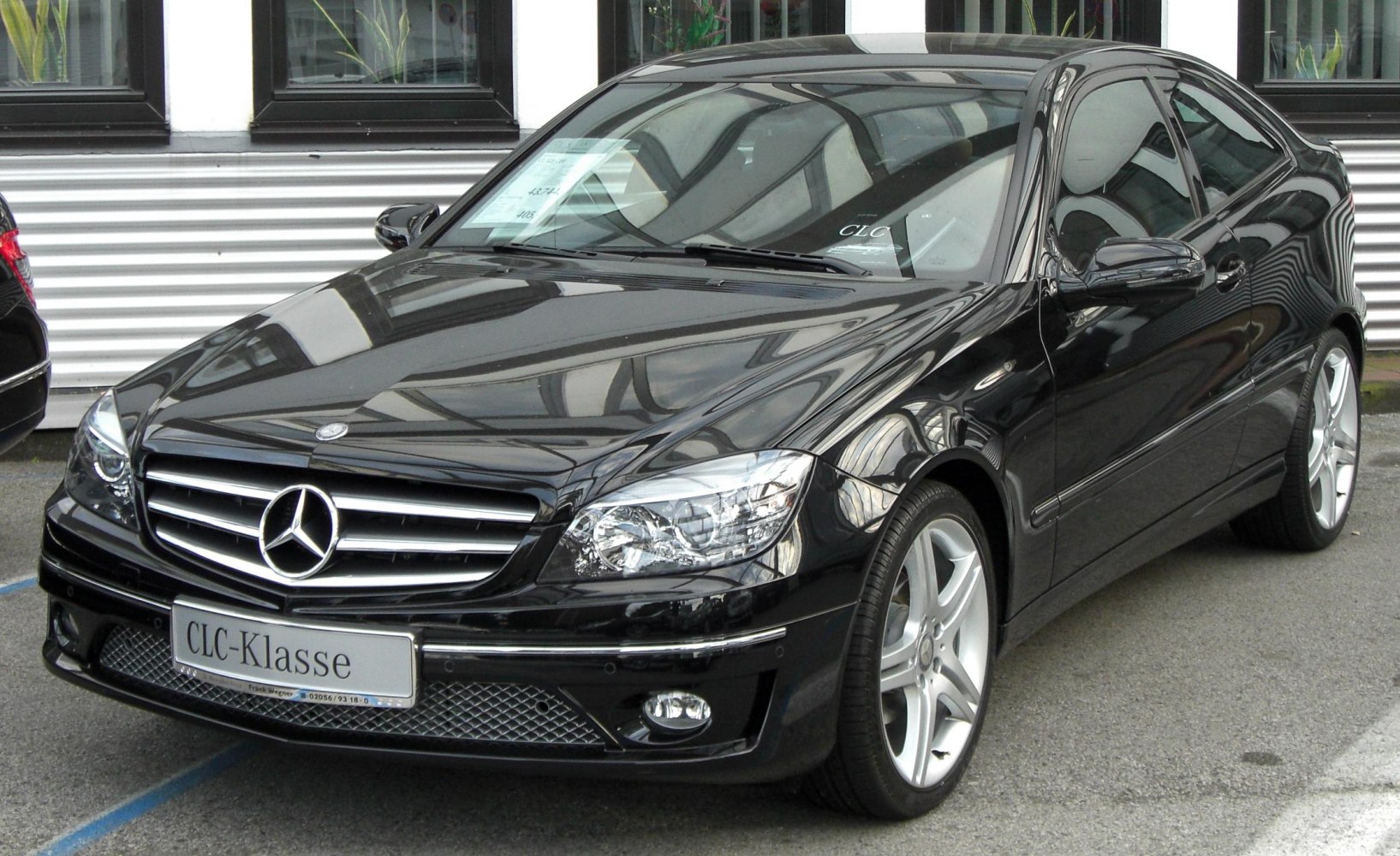 Black luxury sedan front grille and side profile