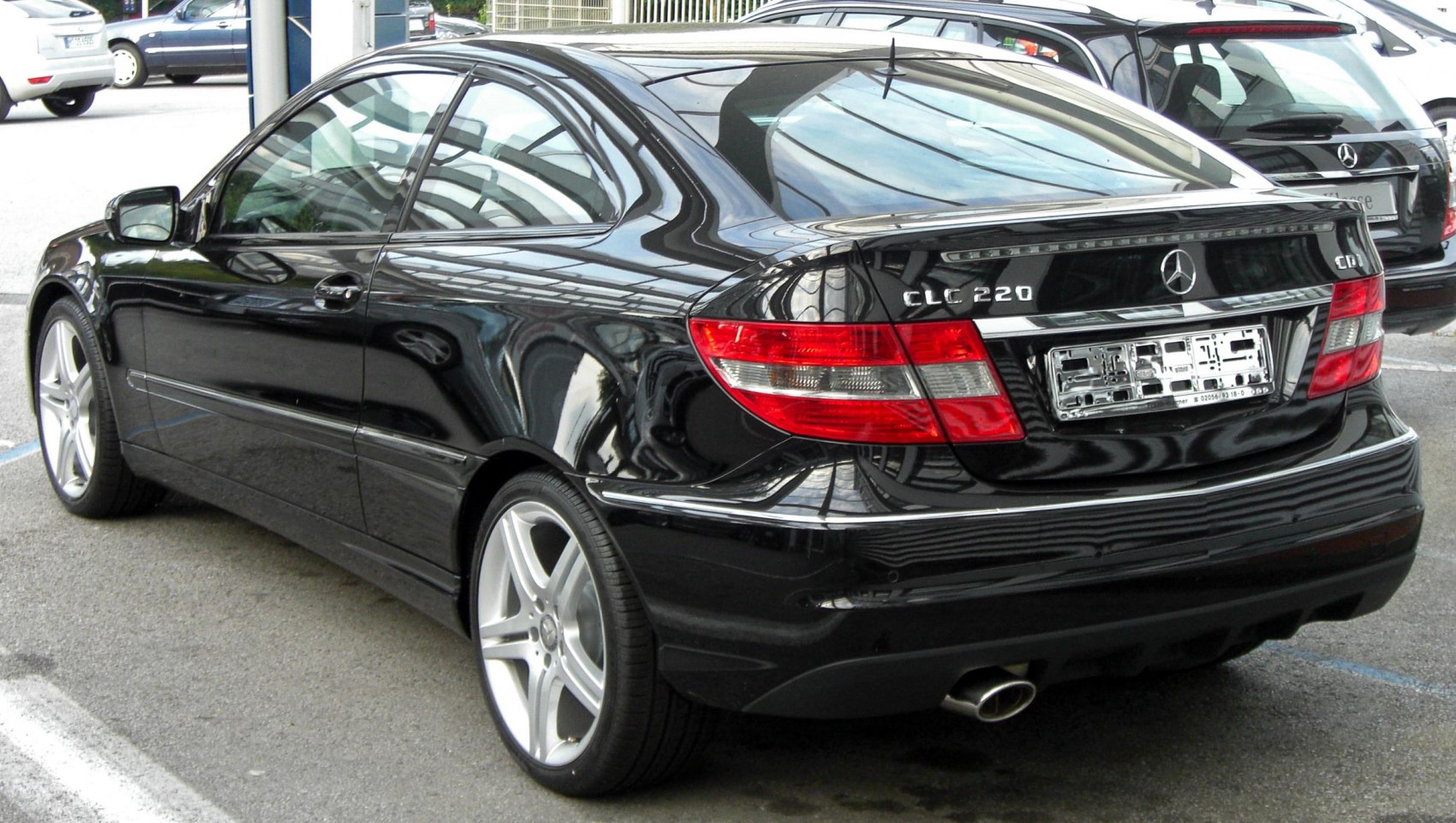 Black coupe rear-side view with distinct taillights and alloy wheels
