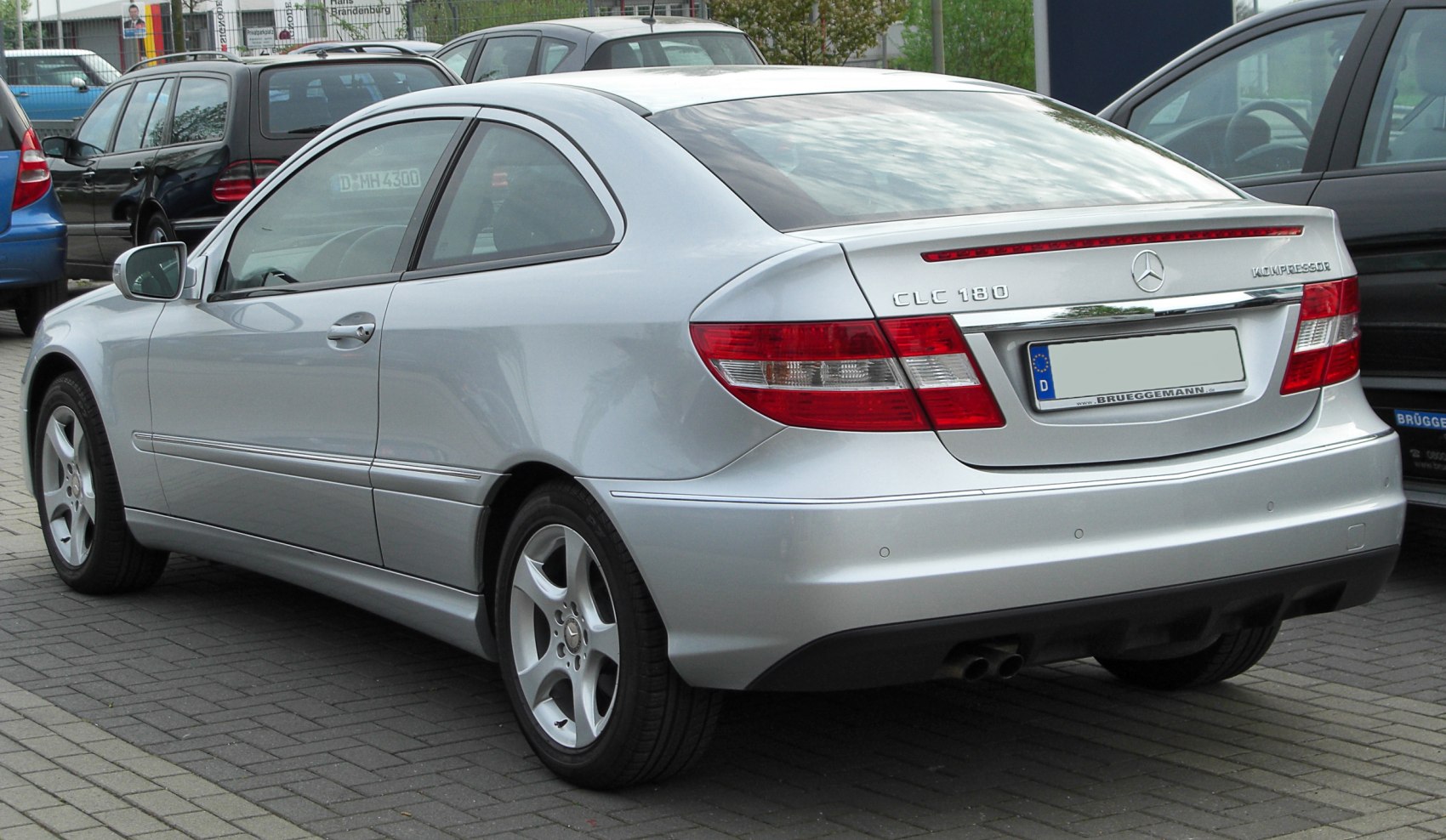 Silver coupe with rear and side view, alloy wheels and distinctive taillights