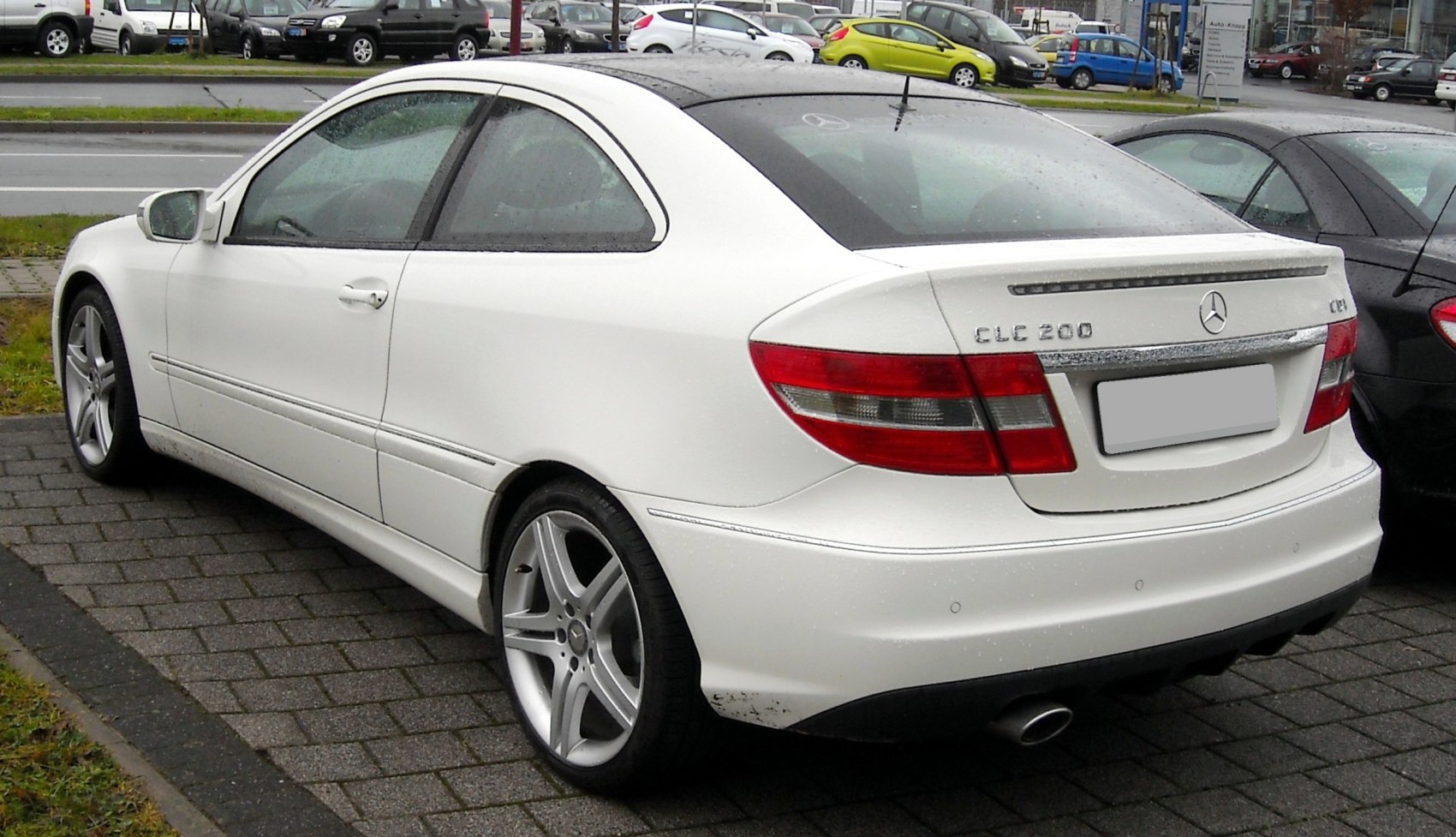 Rear side view of white sporty coupe with alloy wheels