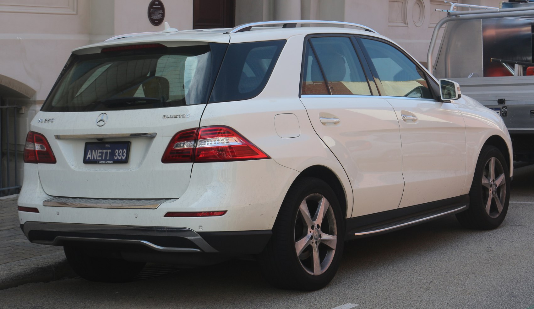 Rear and side view of luxury SUV with LED taillights and roof rails