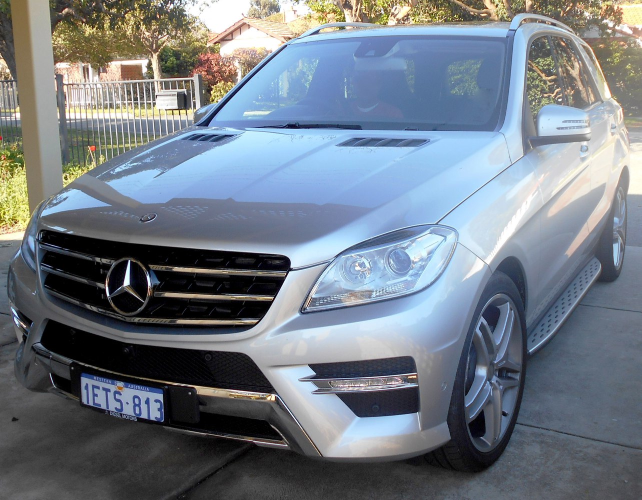 Sporty SUV front with LED lights and hood vents