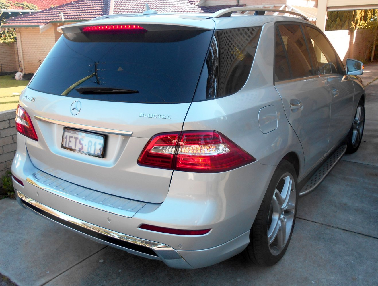 Silver SUV rear with distinctive Mercedes-Benz tail lights and Bluetec badge