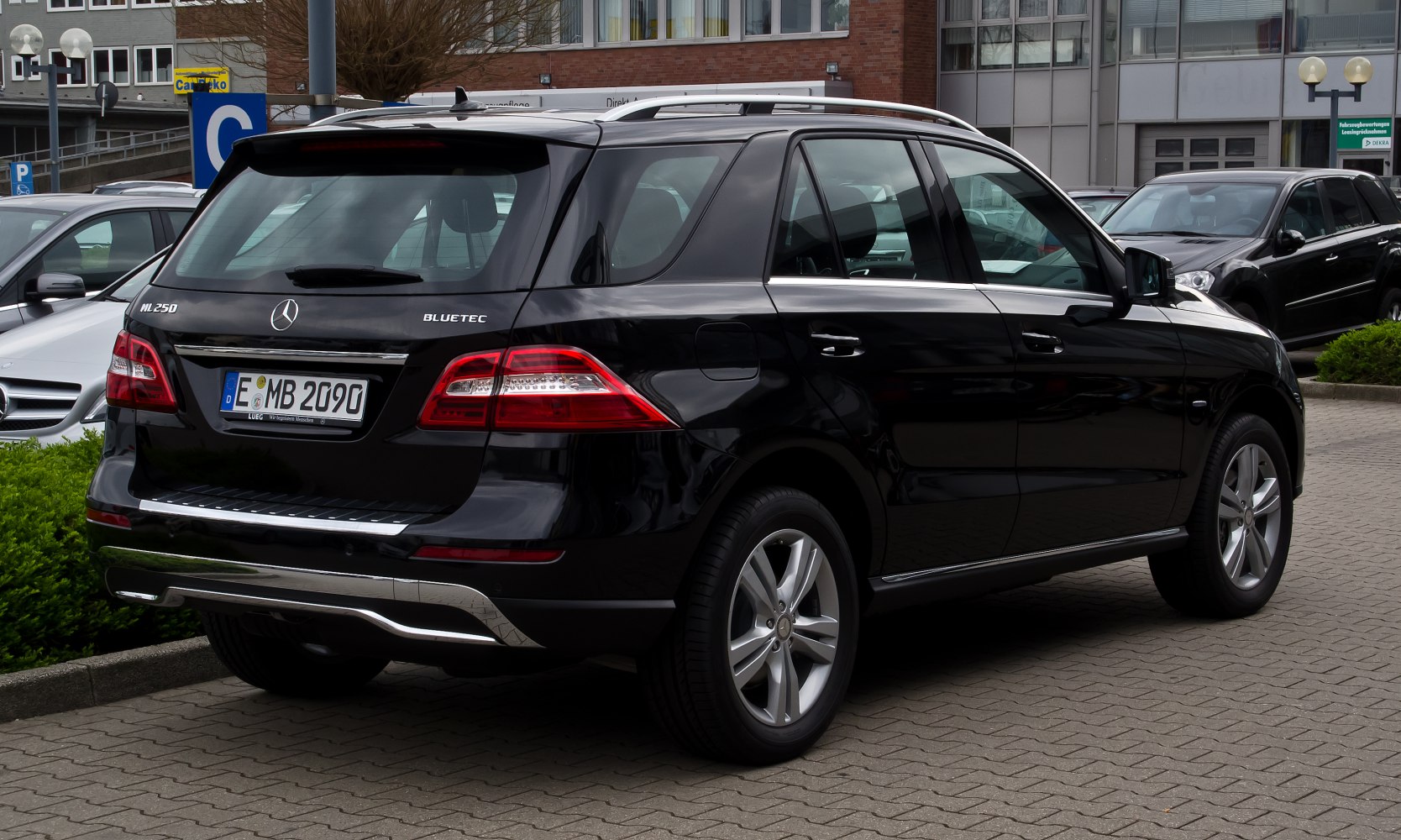 Rear view of black SUV with distinctive taillights and chrome trim