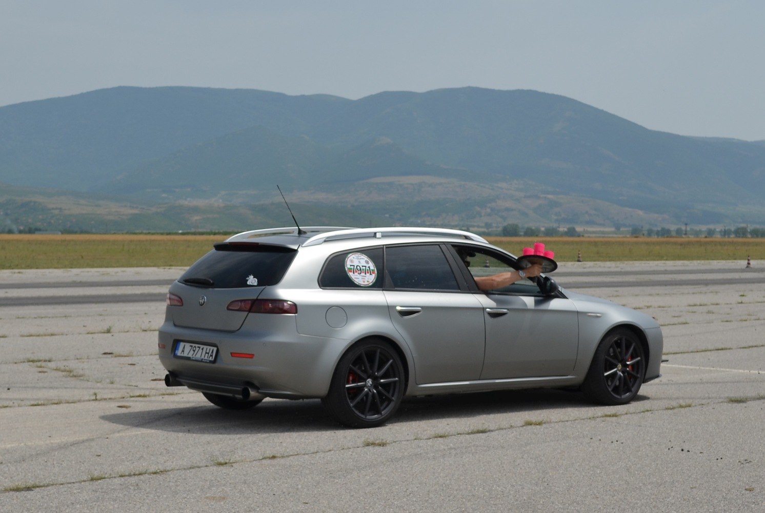 Silver sportwagon with black wheels and rear spoiler
