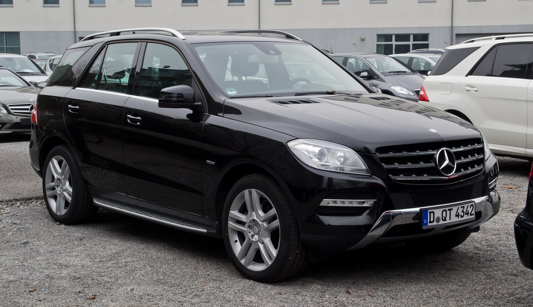 Black SUV front-side view with prominent grille and alloy wheels