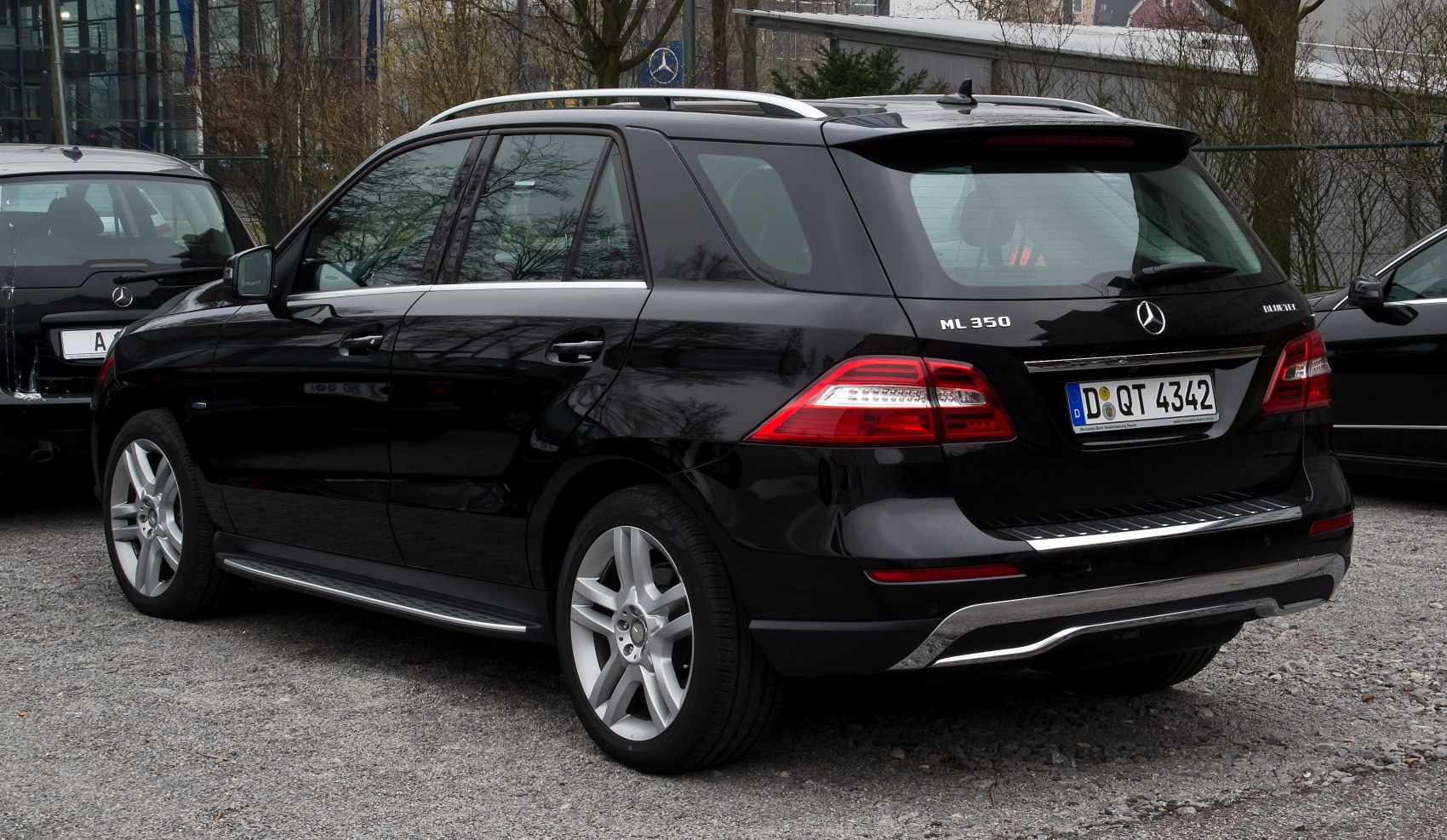 Rear-side view of a luxury SUV with distinct taillights and alloy wheels