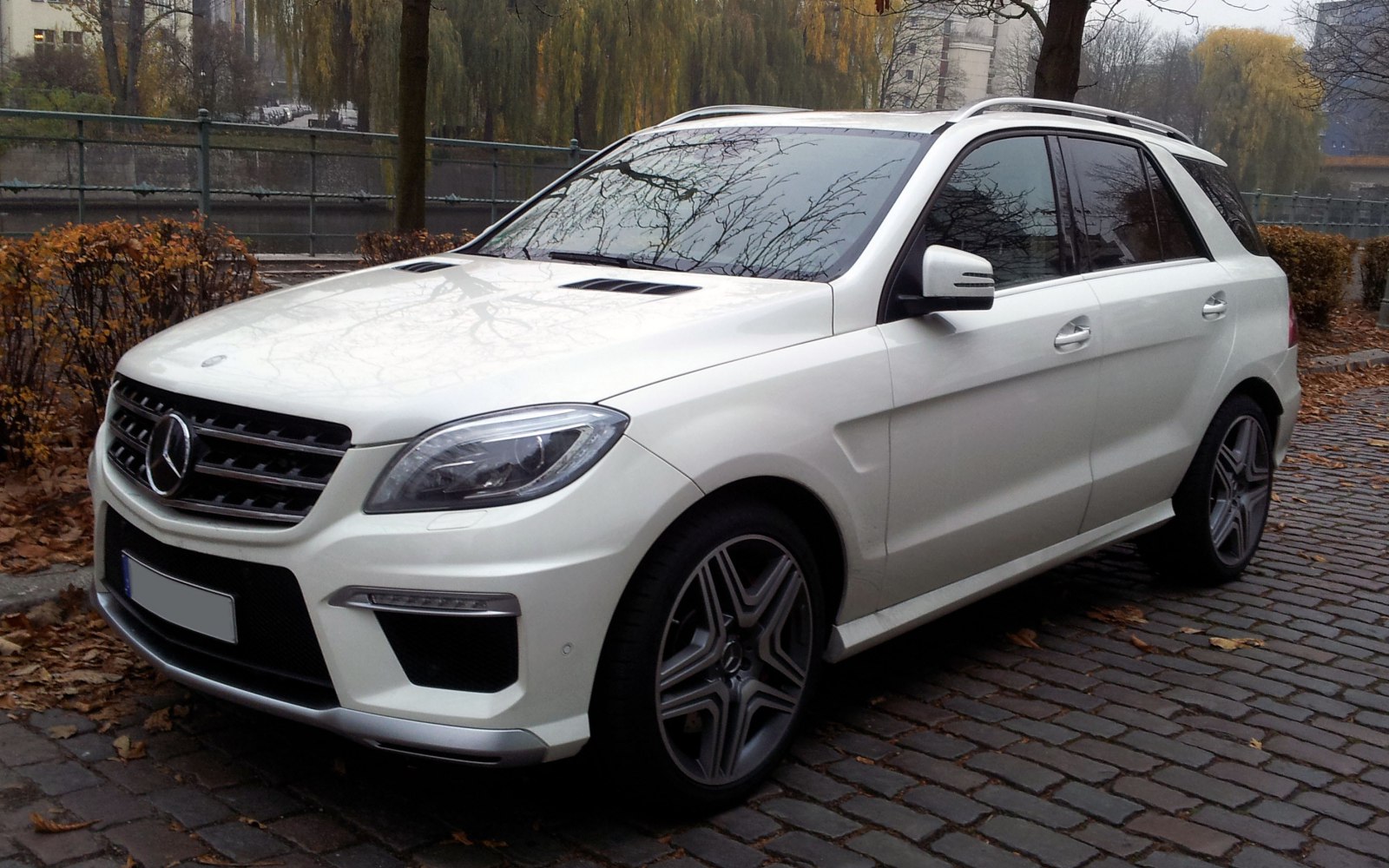 White SUV front side with headlight and grille