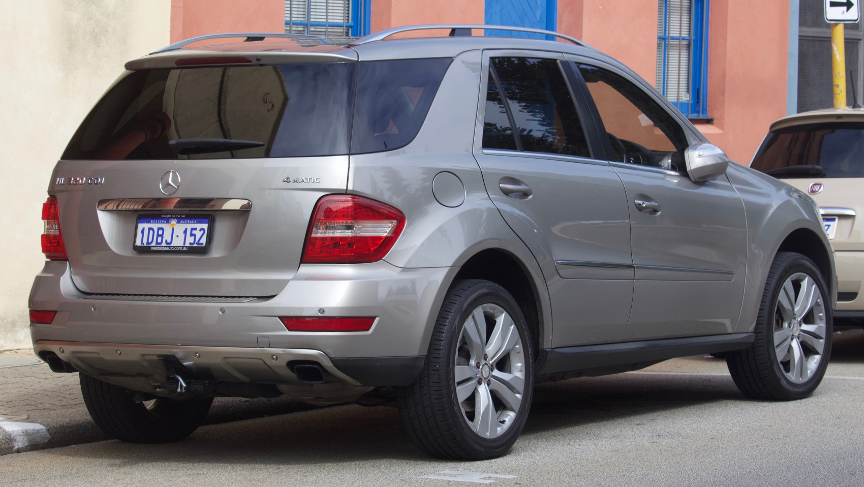 Rear view of a silver luxury SUV with 4MATIC badge and distinctive tail lights