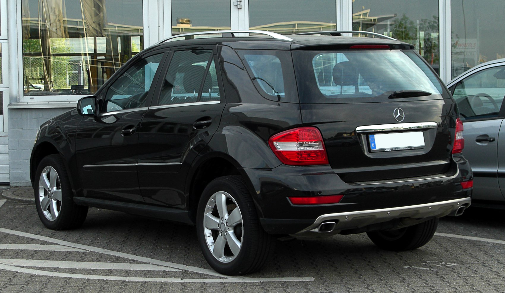 Rear view of black SUV with distinct taillights and dual exhaust
