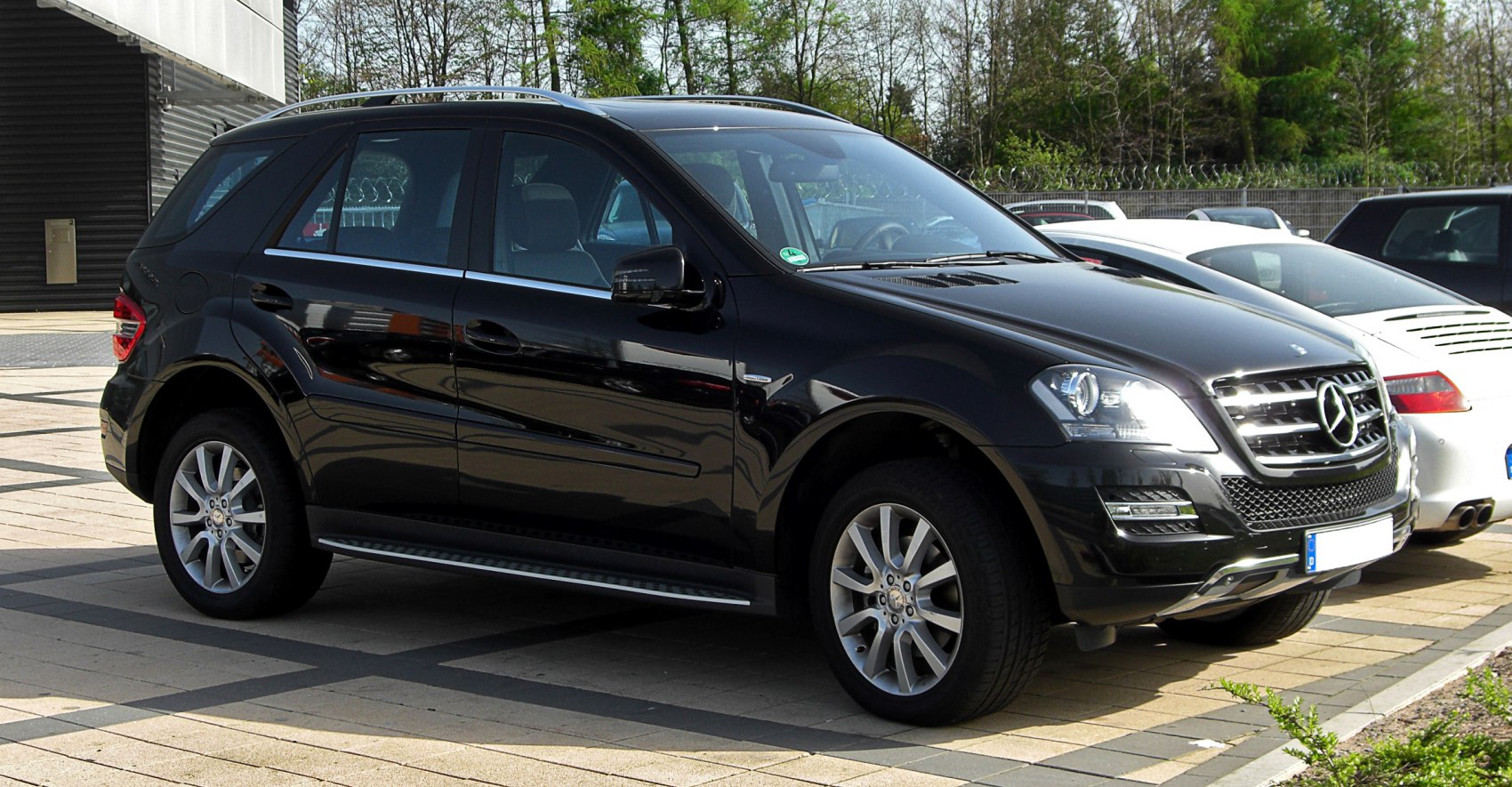 Front-side view of black SUV with distinctive grille and alloy wheels