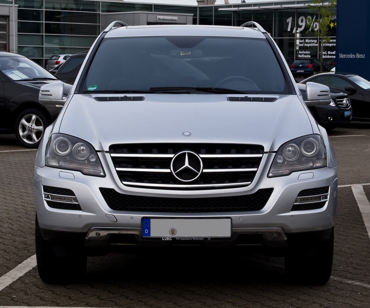 Front view of silver SUV with prominent grille and headlights