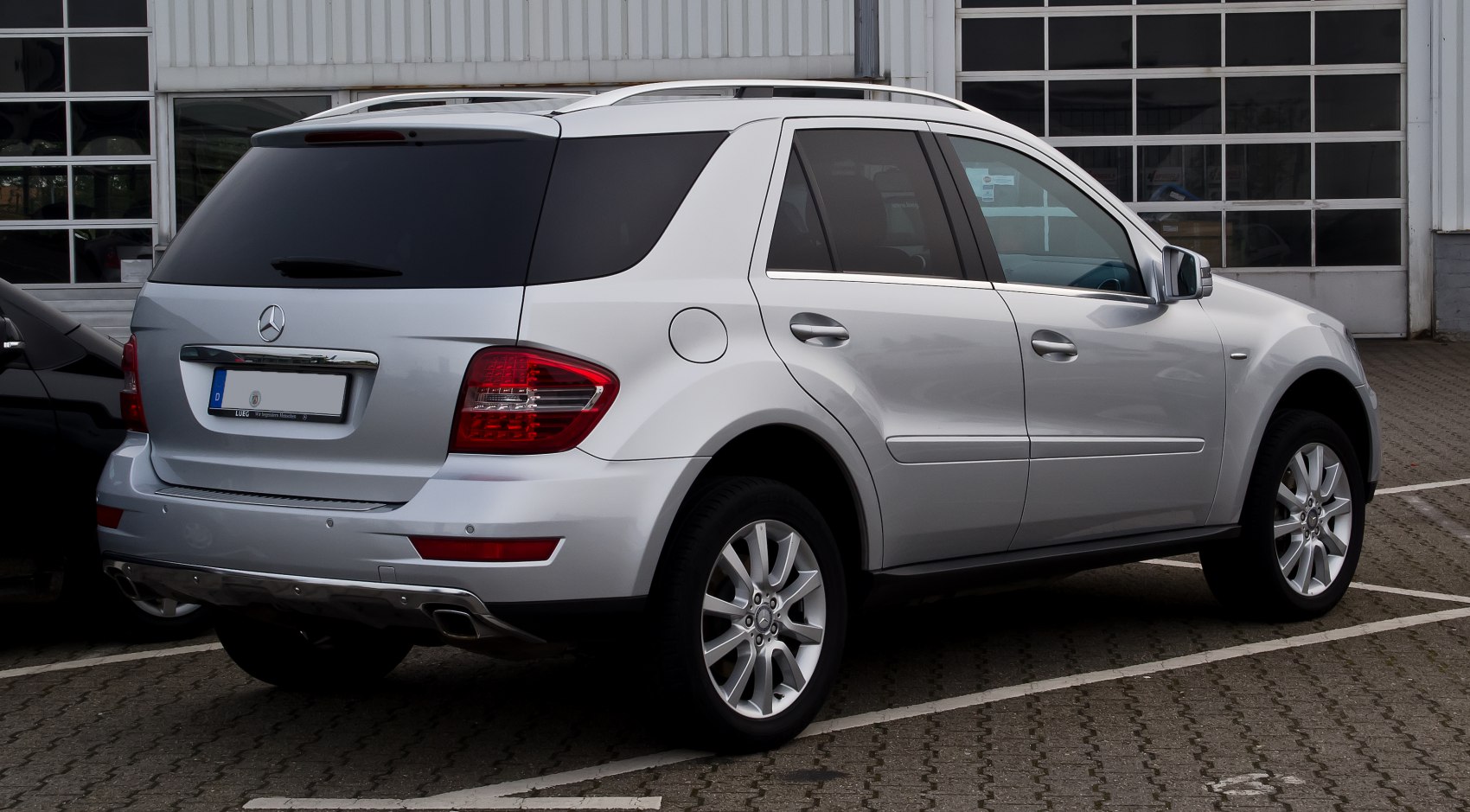 Silver SUV rear side view with alloy wheels and tinted windows