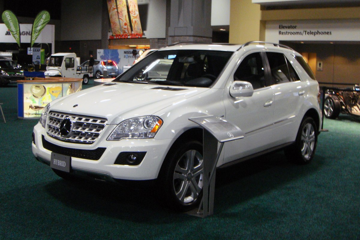 White hybrid SUV with prominent front grille and modern headlights