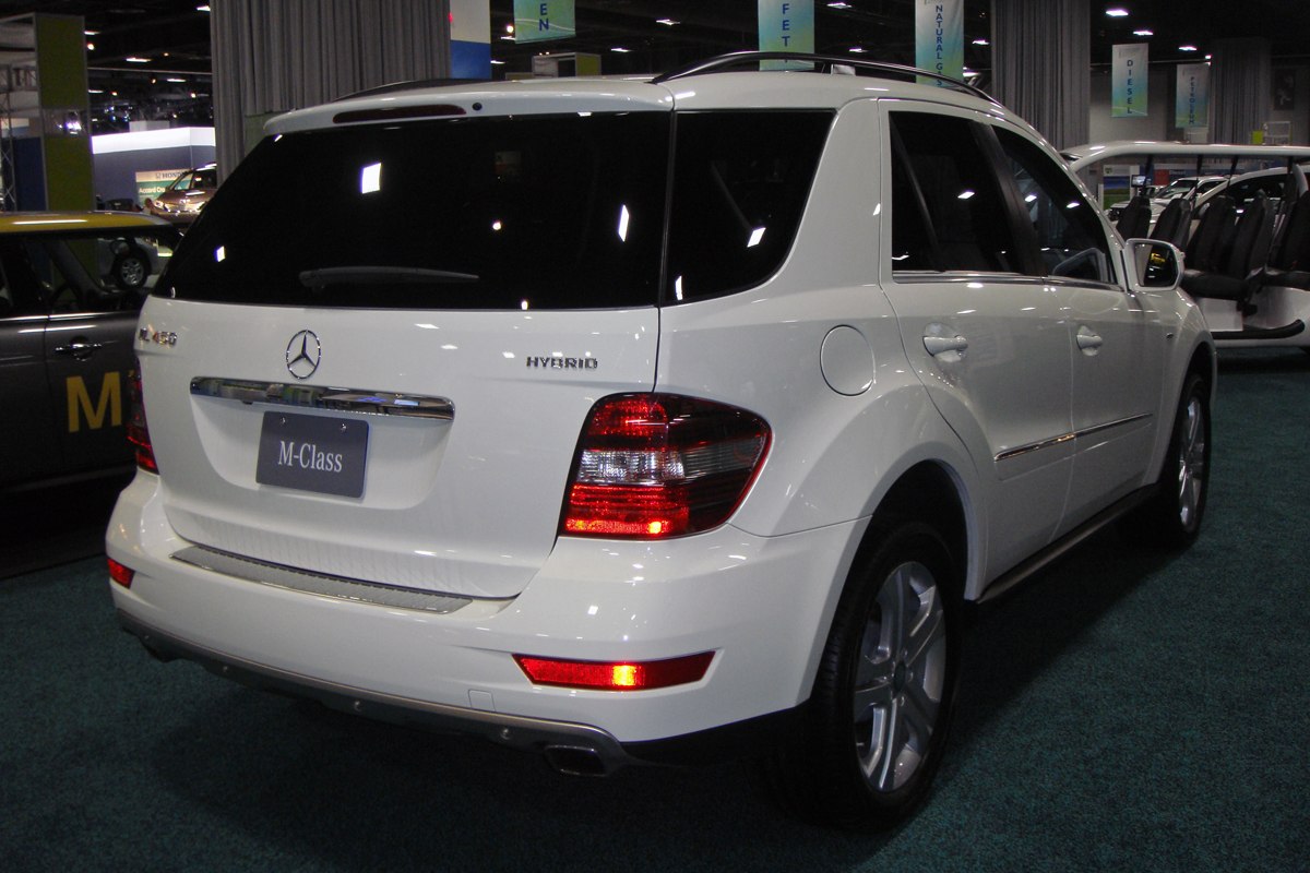 Rear view of white SUV with hybrid badge and distinctive taillights