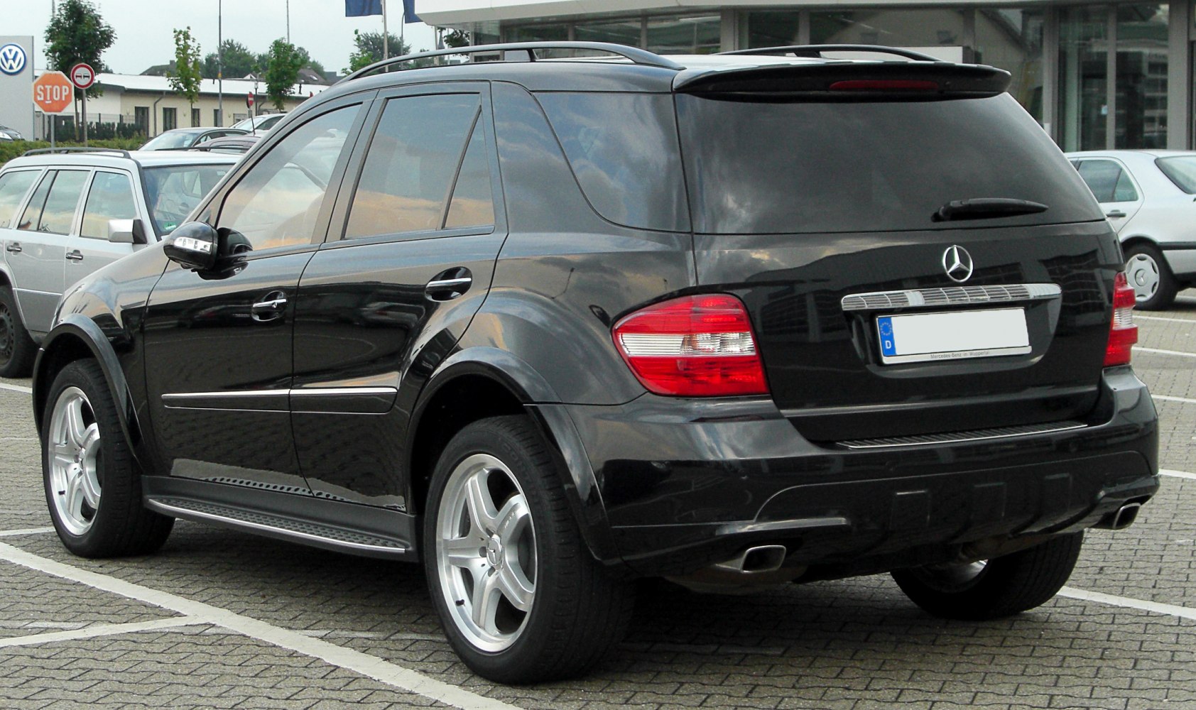 SUV rear side with taillights and black paint