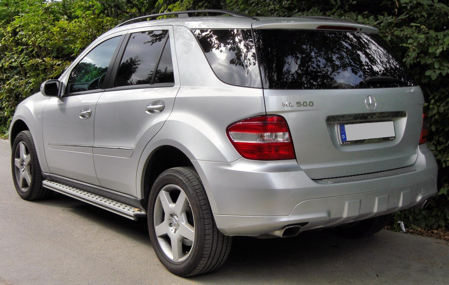 Silver SUV rear side view with alloy wheels and running board