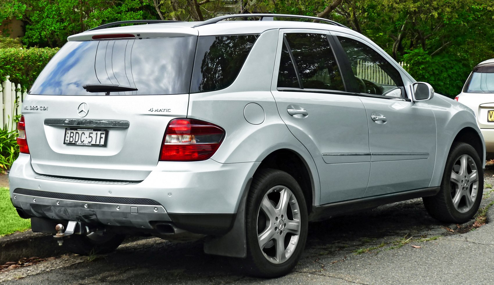 Silver SUV rear side with roof rails and alloy wheels