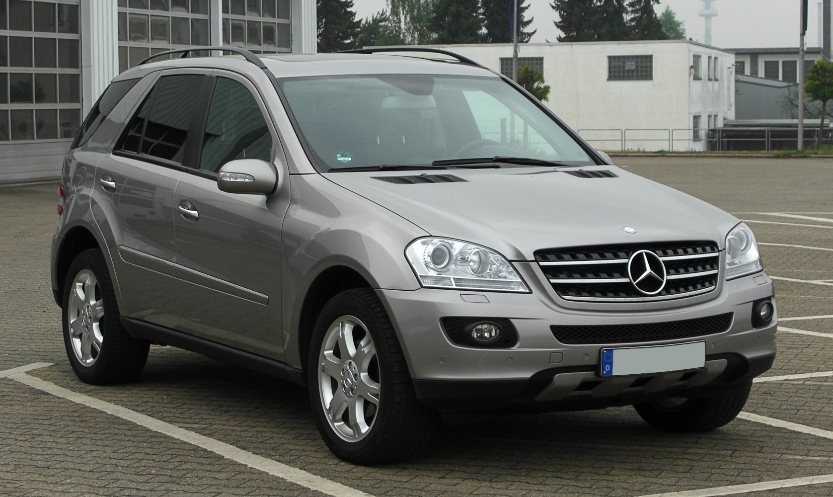 Silver SUV front side with alloy wheels and roof rails