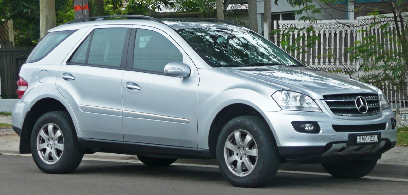 Silver SUV front side view with curved roofline and prominent wheel arches