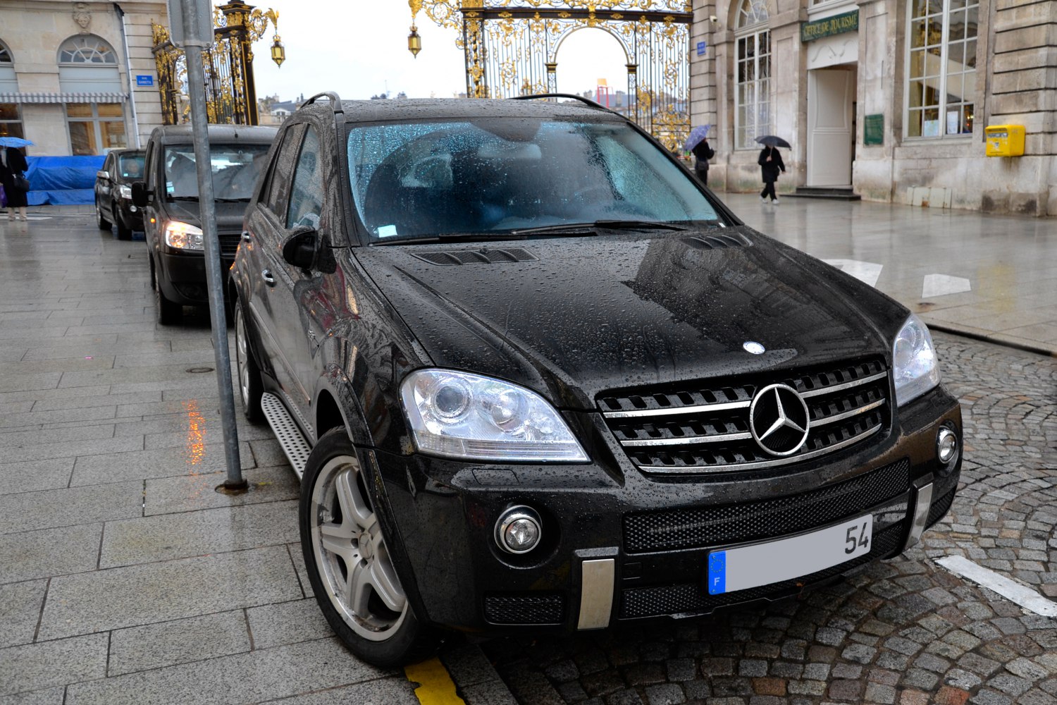 Front view of SUV with wet rain droplets and highlighted grille and headlights