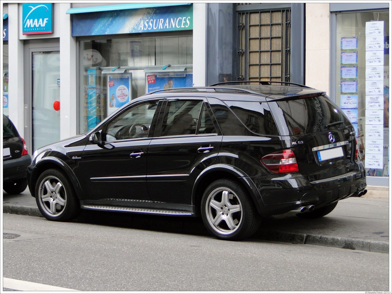 Black luxury SUV rear side view with alloy wheels