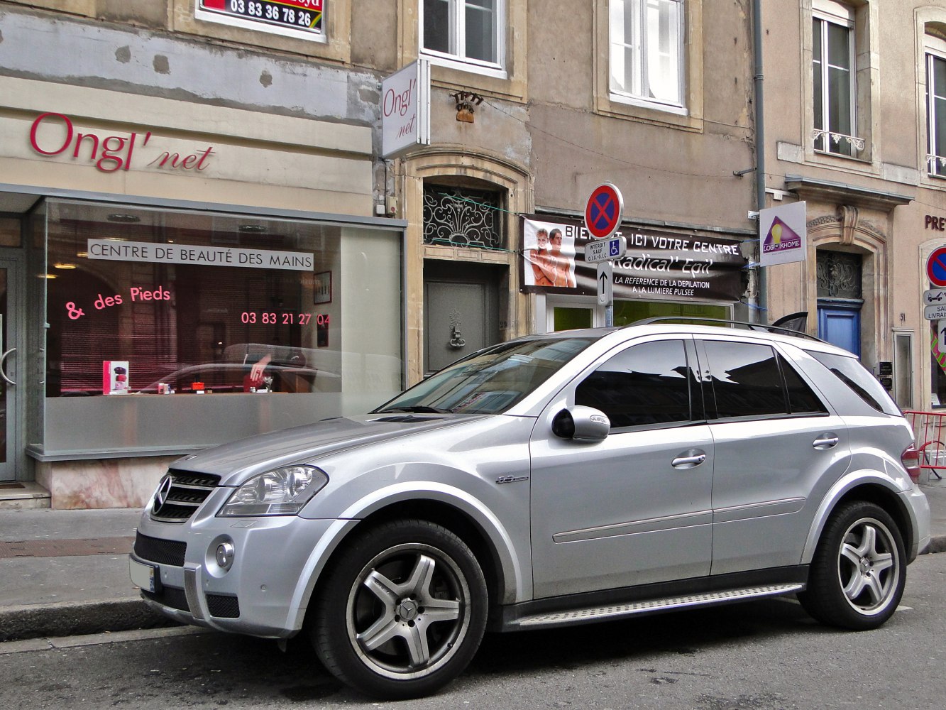 Silver luxury SUV with AMG wheels and tinted windows