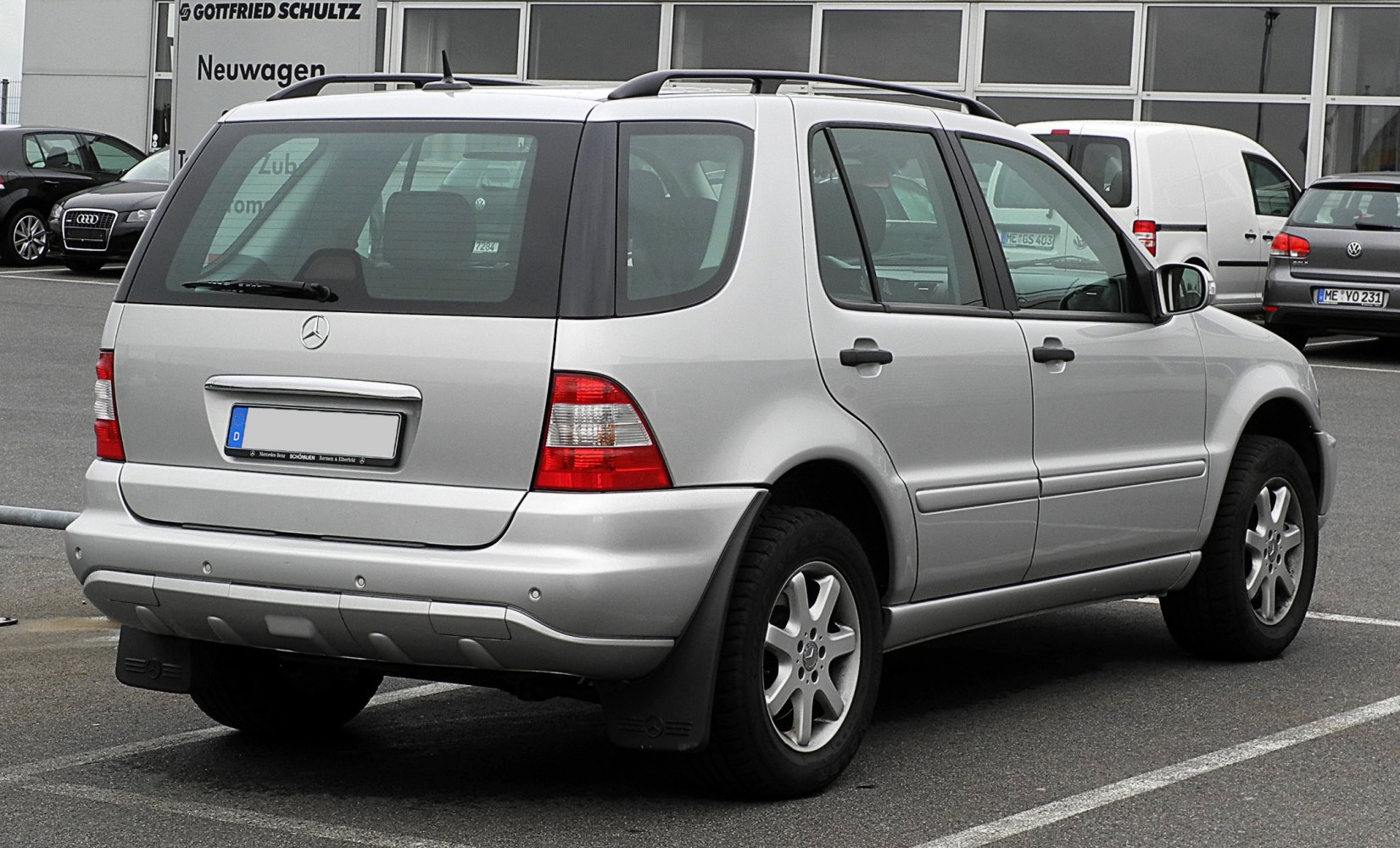 Silver mid-size SUV rear and side view with distinct tail lights and alloy wheels