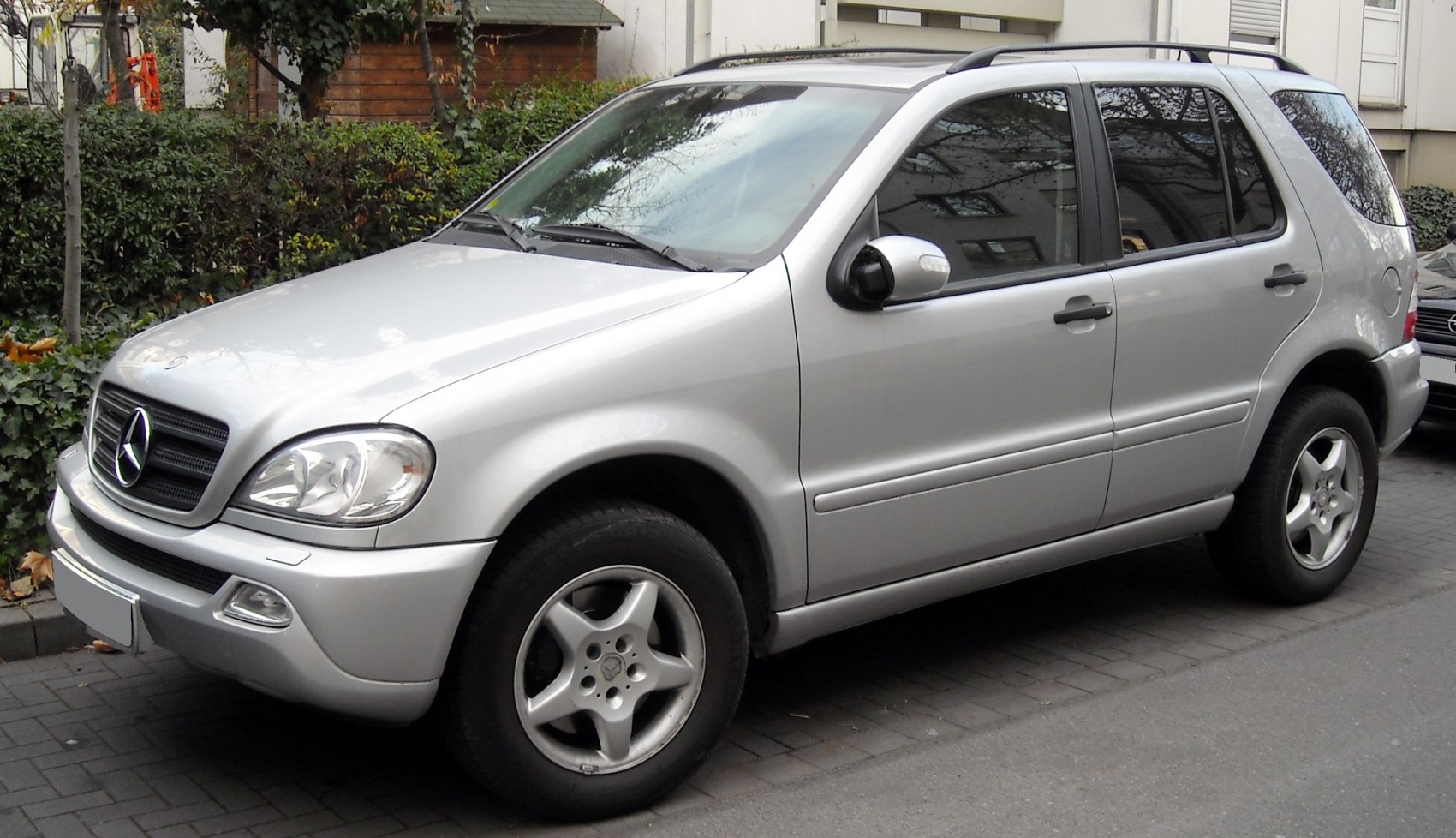 Silver mid-size SUV front and side view with alloy wheels