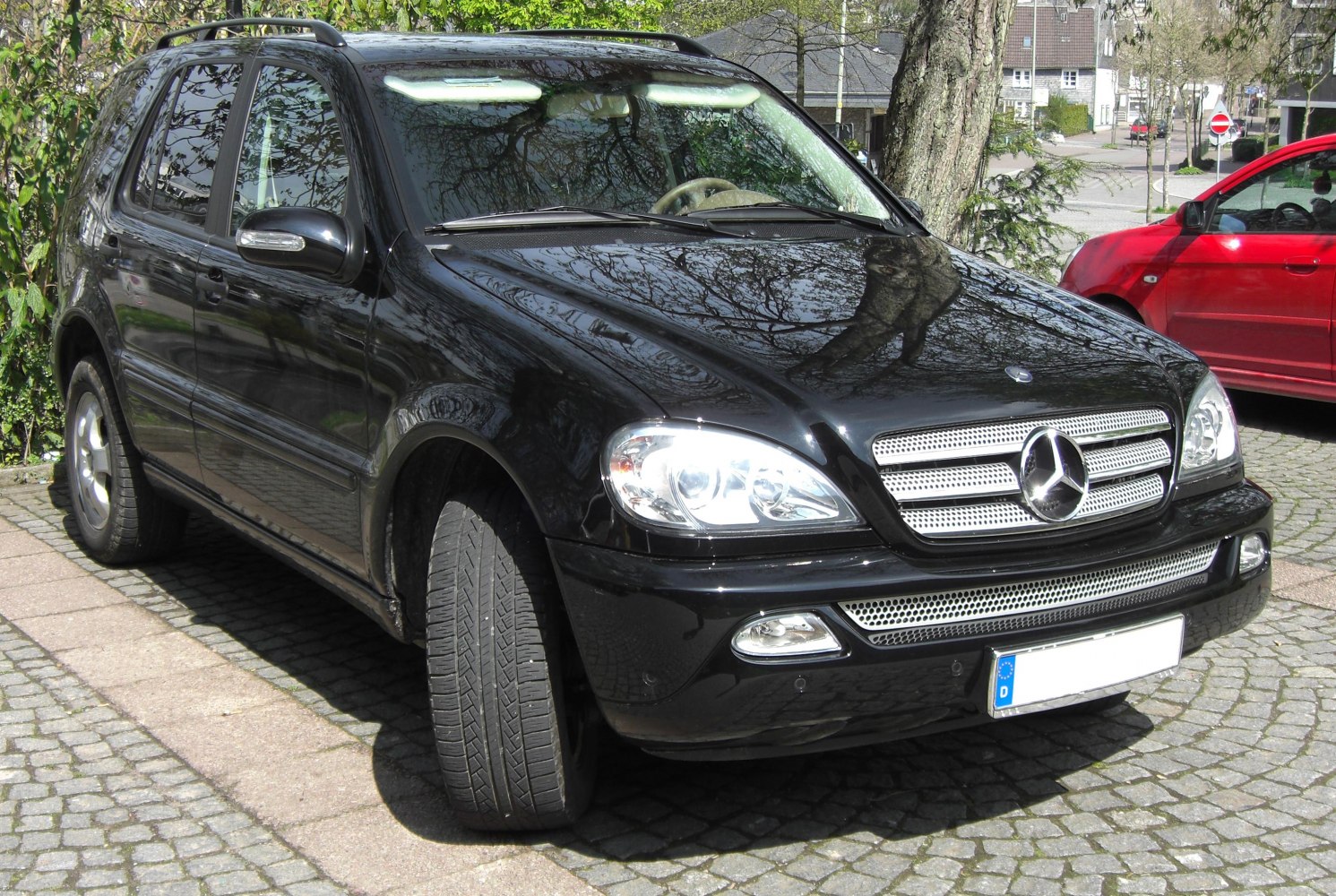 Front angled SUV view with mesh grille and clear headlights