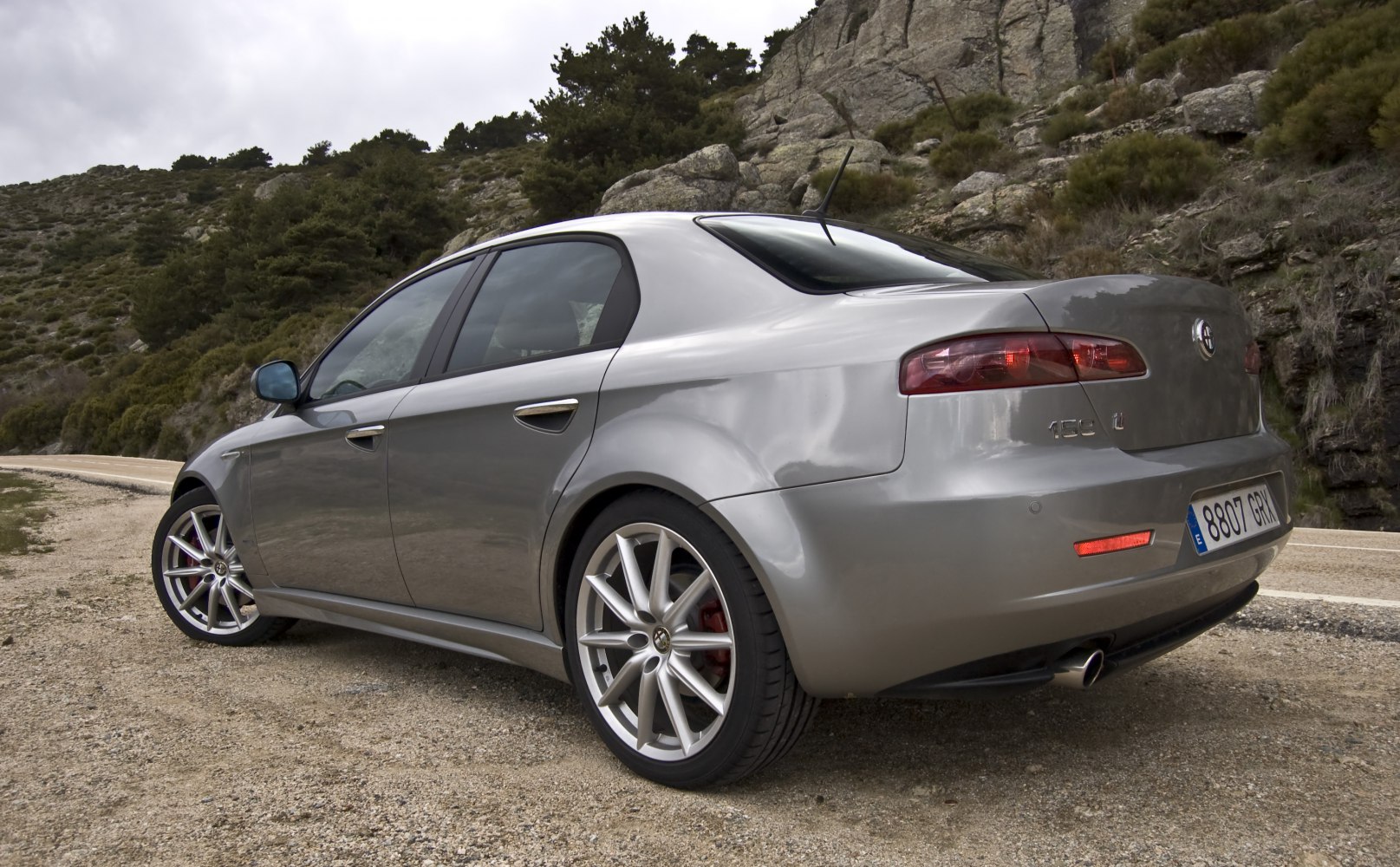 Silver sedan rear and side view with alloy wheels and distinct rear lights