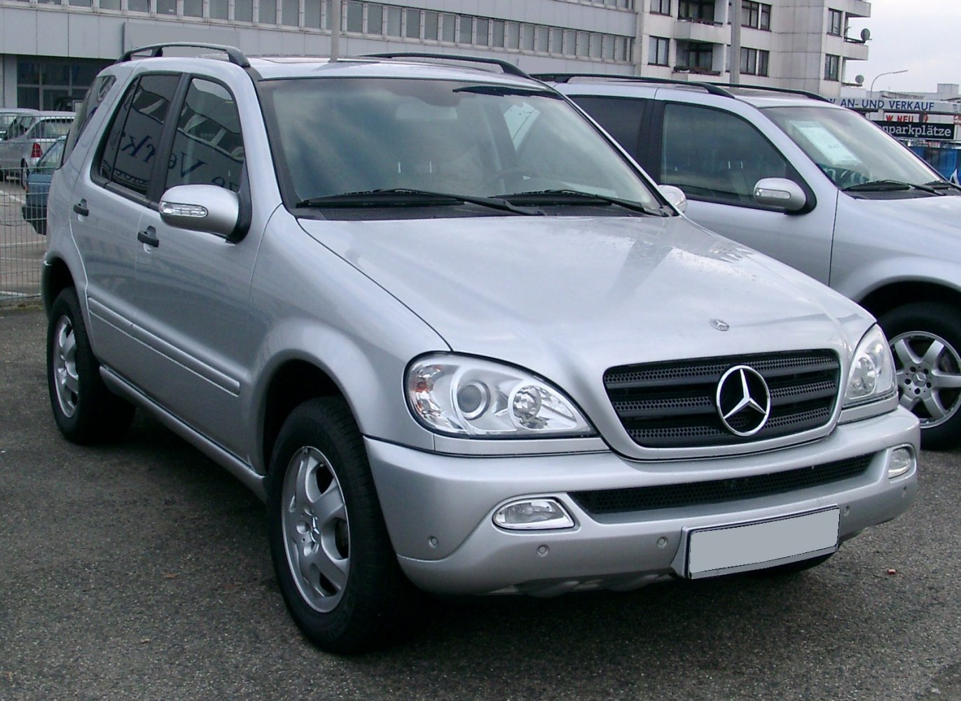 Front view of a silver SUV with distinctive headlights and grille