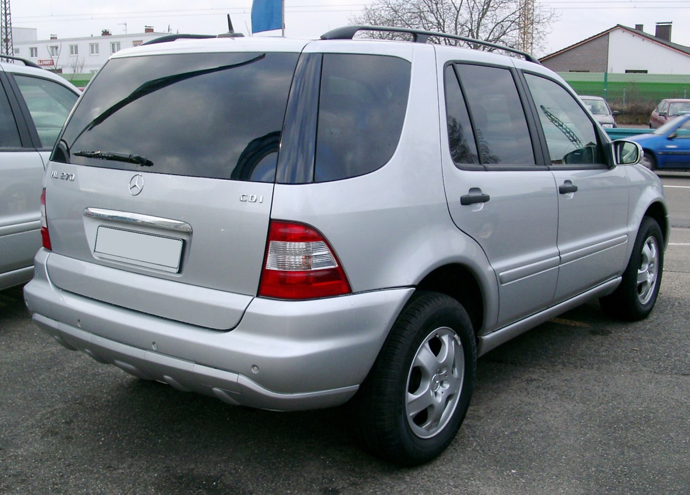Rear view of mid-size SUV with tinted windows and alloy wheels