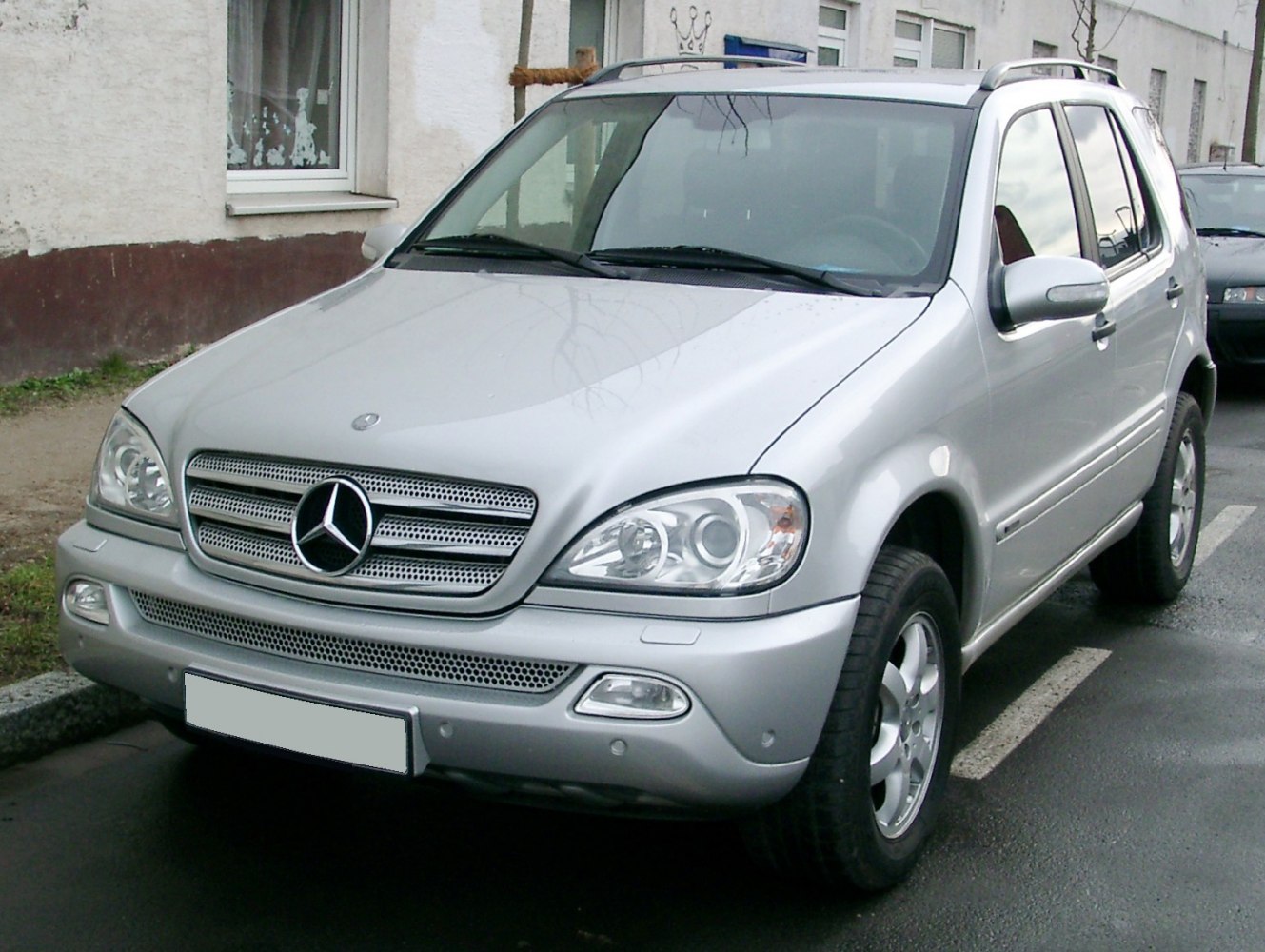 Front-angle view with prominent grille and circular headlights