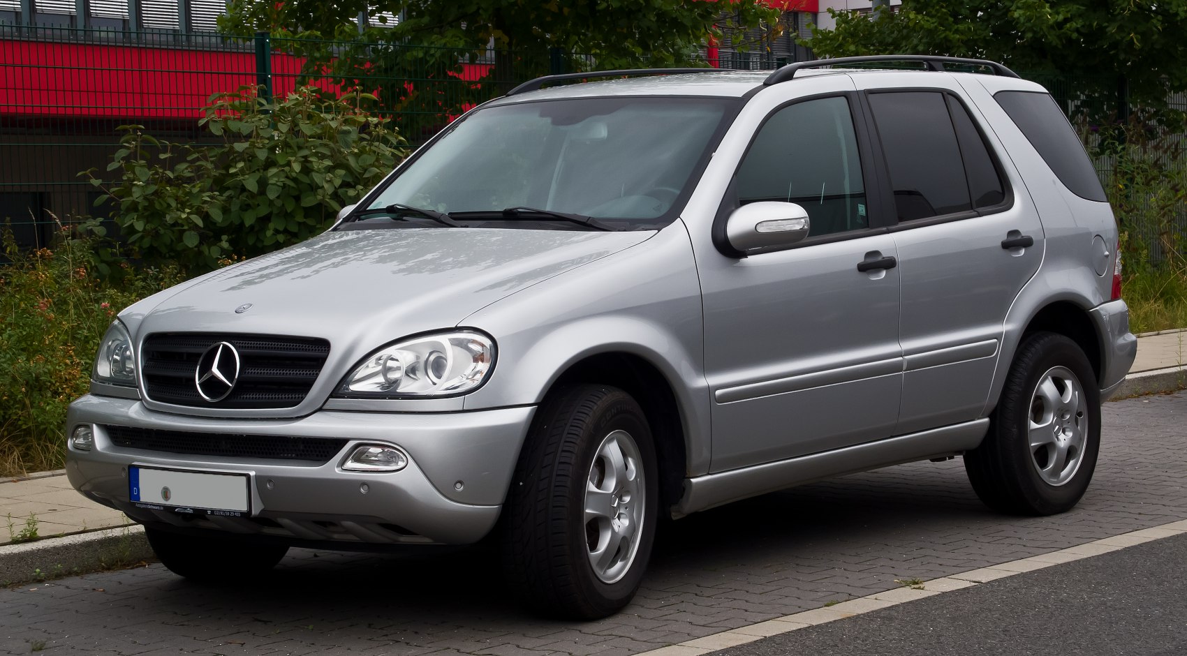 Silver SUV with distinctive grille and alloy wheels front side view