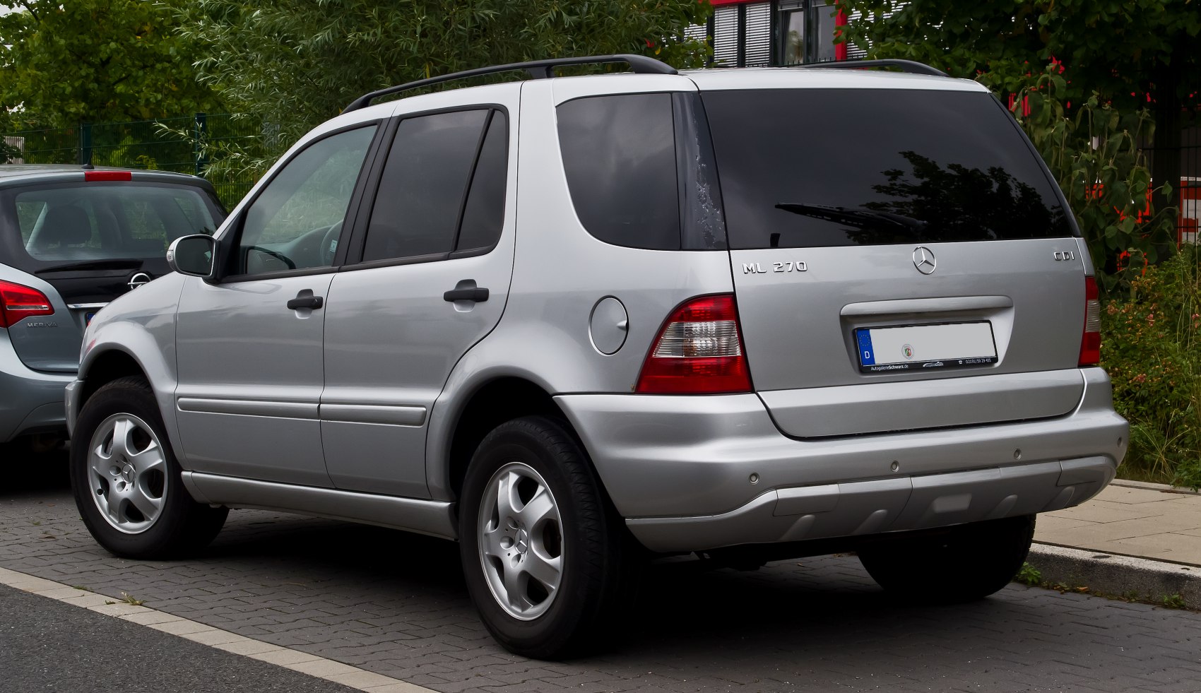 Rear side view of silver SUV with alloy wheels and tinted rear windows
