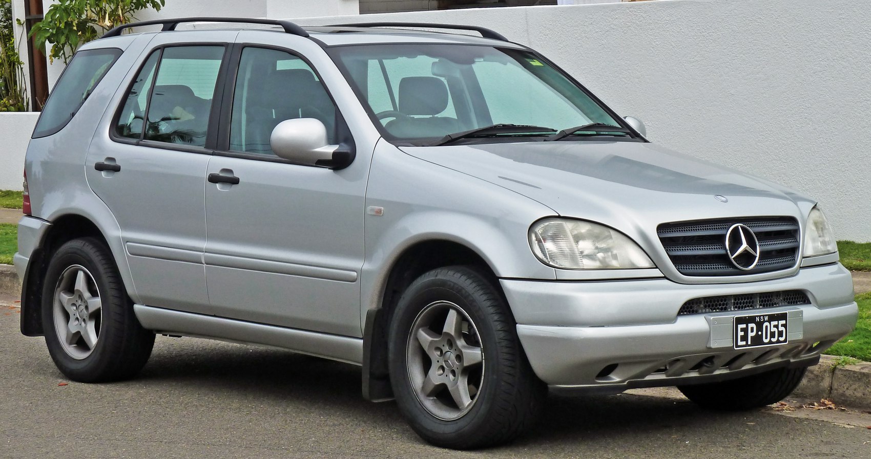 Silver SUV front and side view with roof rails and alloy wheels