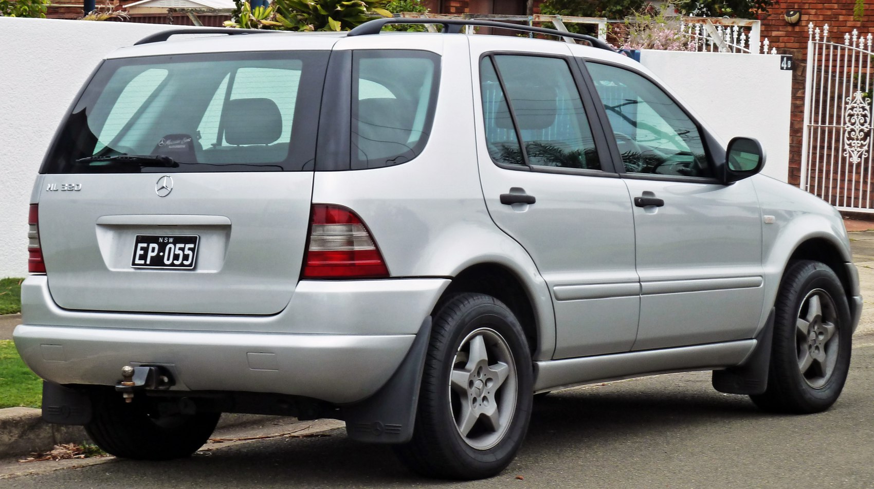 Silver SUV rear view with roof rails and tow hitch