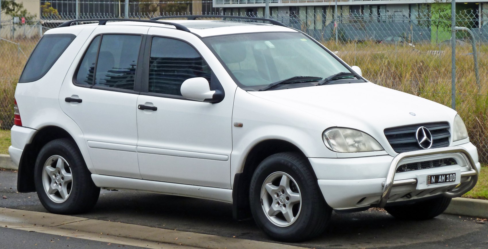 White SUV with chrome bull bar and five-spoke alloy wheels